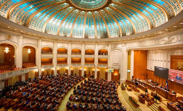 Romanian Prime Minister designate Luca Niculescu addresses a joint parliament session called to give a vote of confidence for the new government team, in Bucharest, Romania, Tuesday, Oct. 20, 2026. (AP Photo/Andreea Alexandru)