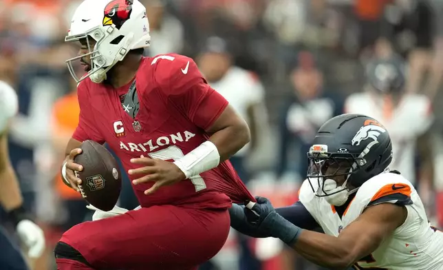 Arizona Cardinals quarterback Jacoby Brissett (7) avoids a sack by Denver Broncos linebacker Nik Bonitto (15) during the first quarter of an NFL football game in Glendale, Ariz., Sunday, Oct. 25, 2026. (AP Photo/Ross D. Franklin)