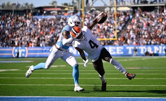 Cleveland Browns quarterback Deshaun Watson (4) scores a touchdown past Tennessee Titans safety Kevin Winston Jr. (23) during the second half of an NFL football game in Nashville, Tenn., Sunday, Oct. 25, 2026. (AP Photo/John Amis)