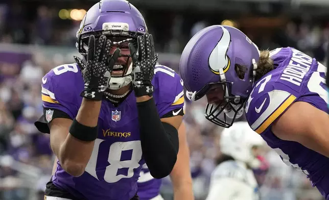 Minnesota Vikings wide receiver Justin Jefferson (18) celebrates after a touchdown by tight end T.J. Hockenson, right, during the second half of an NFL football game against the Indianapolis Colts in Minneapolis, Sunday, Oct. 25, 2026. (AP Photo/Ellen Schmidt)