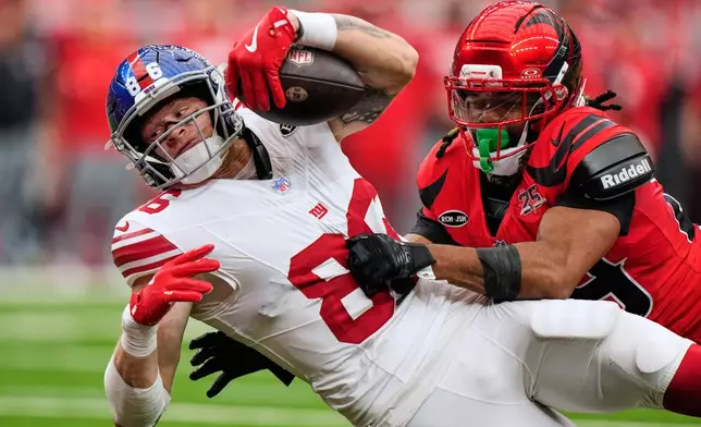 New York Giants tight end Thomas Fidone II (86) dives into the end zone for a touchdown with Houston Texans safety M.J. Stewart, right,) defending during the first half of an NFL football game in Houston, Sunday, Oct. 25, 2026. (AP Photo/Gerald Herbert)