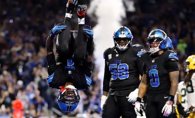 Detroit Lions wide receiver Jameson Williams (1) does a flip after catching a touchdown pass during the second half of an NFL football game against the Green Bay Packers, Sunday, Oct. 25, 2026, in Detroit. (AP Photo/Rey Del Rio)