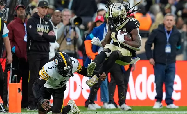 New Orleans Saints running back Alvin Kamara (41) is tackled by Pittsburgh Steelers cornerback Jalen Ramsey (5) during an NFL football game in Saint-Denis, outside Paris, Sunday, Oct. 25, 2026. (AP Photo/Steve Luciano)
