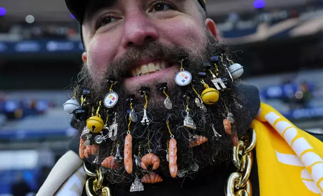 The beard of a Steelers fan is adorned with French related ephemera ahead of an NFL football game between Pittsburgh Steelers and New Orleans Saints in Saint-Denis, outside Paris, Sunday, Oct. 25, 2026. (AP Photo/Aurelien Morissard)