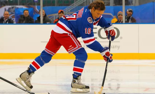 FILE - Ron Duguay of the New York Rangers Alumni team moves the puck into the offensive zone during the Winter Classic Alumni hockey game with the Philadelphia Flyers Alumni team, Saturday, Dec. 31, 2011 in Philadelphia. (AP Photo/Tom Mihalek, File)