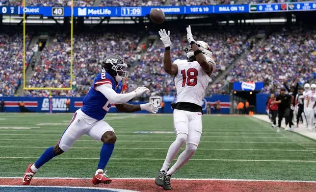 Arizona Cardinals wide receiver Marvin Harrison Jr. (18) makes a touchdown catch against New York Giants cornerback Deonte Banks (2) during an NFL football game, in East Rutherford, N.J., Sunday, Oct. 4, 2026. (AP Photo/Seth Wenig)