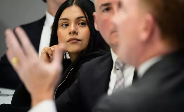 Marimar Martinez, a Chicago woman who was shot by a Border Patrol agent last year, listens to attorney Michael Gallagher at a press conference Monday, Oct. 5, 2026, in Chicago. (AP Photo/Nam Y. Huh)