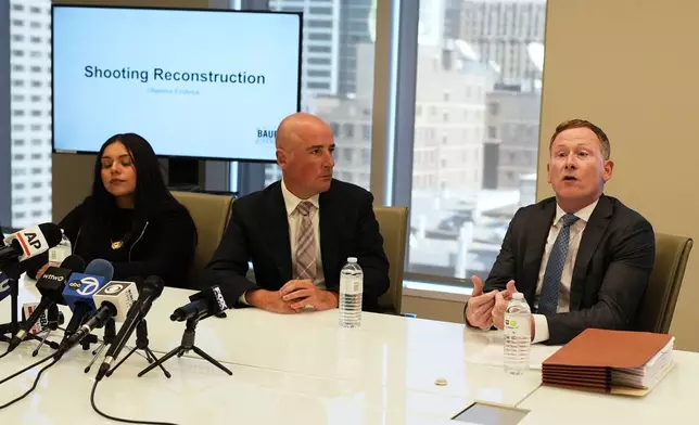 Attorney Michael Gallagher, right, talks to media as attorney Christopher Parente, center, and Marimar Martinez, a Chicago woman who was shot by a Border Patrol agent last year, listens to him at a press conference Monday, Oct. 5, 2026, in Chicago. (AP Photo/Nam Y. Huh)