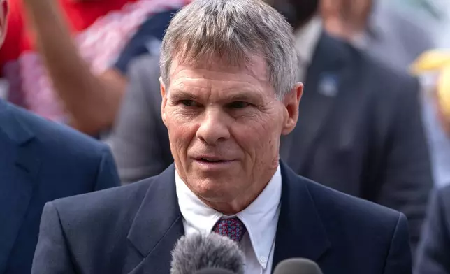 FILE - Former Olympic canoeist David Hearn, speaks to reporters outside the District of Columbia Courthouse, Sept. 4, 2026, in Washington, following a hearing concerning the dismissal of charges against him for allegedly damaging the Lincoln Memorial Reflecting Pool. (AP Photo/Mark Schiefelbein, File)