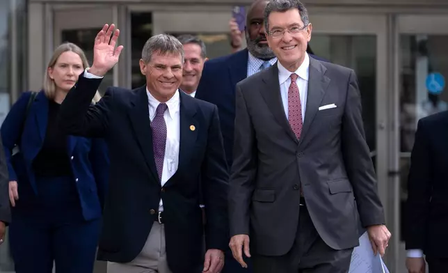 FILE - Former Olympic canoeist David Hearn, left, and his attorney Norm Eisen, right, leave the District of Columbia Courthouse, Sept. 4, 2026, in Washington, following a hearing concerning the dismissal of charges against him for allegedly damaging the Lincoln Memorial Reflecting Pool. (AP Photo/Mark Schiefelbein, File)
