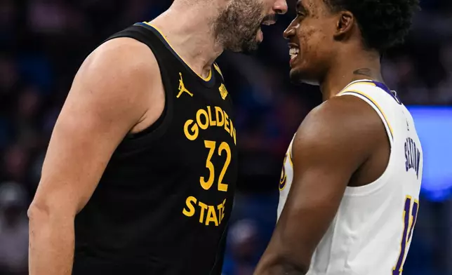 Golden State Warriors forward Georges Niang (32) and Los Angeles Lakers guard Collin Sexton, right, have words during the first half of an NBA Cup basketball game, Saturday, Oct. 30, 2026, in San Francisco. (AP Photo/Justine Willard)