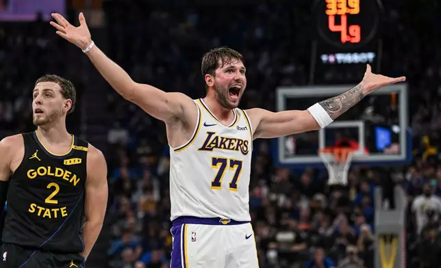 Los Angeles Lakers guard Luka Doncic (77) looks for a foul call during the first half of an NBA Cup basketball game against the Golden State Warriors, Saturday, Oct. 30, 2026, in San Francisco. (AP Photo/Justine Willard)