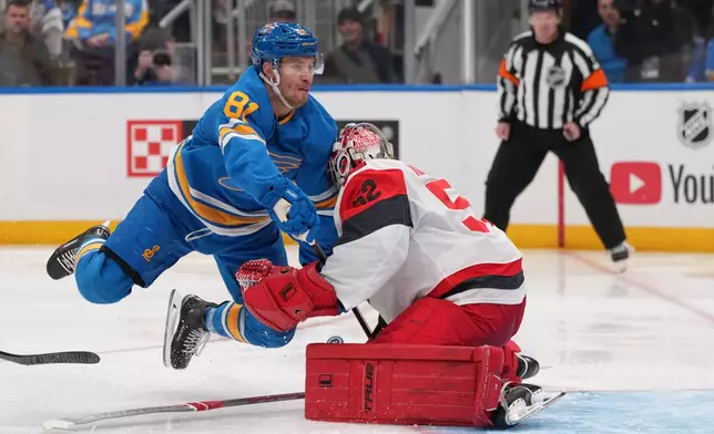 St. Louis Blues' Dylan Holloway (81) collides with Carolina Hurricanes goaltender Pyotr Kochetkov (52) during the second period of an NHL hockey game Saturday, Oct. 24, 2026, in St. Louis. (AP Photo/Jeff Roberson)