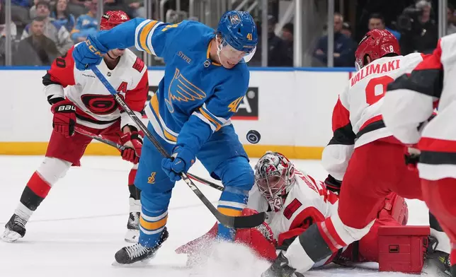 St. Louis Blues' Aleksanteri Kaskimaki (41) watches the puck as Carolina Hurricanes goaltender Pyotr Kochetkov, right, defends during the second period of an NHL hockey game Saturday, Oct. 24, 2026, in St. Louis. (AP Photo/Jeff Roberson)