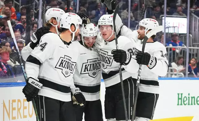 Los Angeles Kings' Artemi Panarin (10) celebrates with teammates after scoring during the first period of an NHL hockey game against the New York Islanders, Thursday, Oct. 22, 2026, in Elmont, N.Y. (AP Photo/Frank Franklin II)