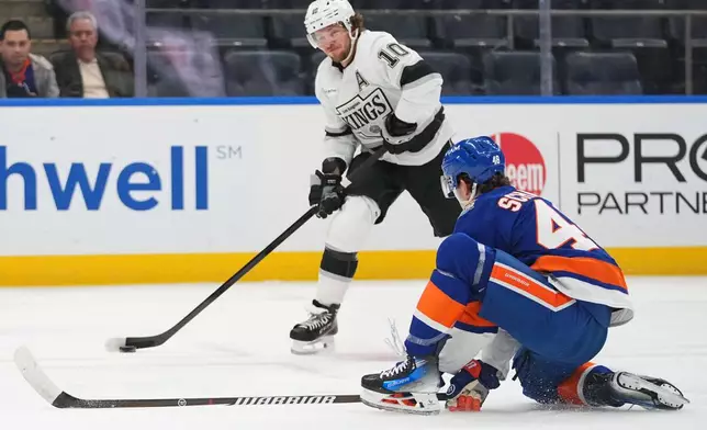 New York Islanders' Matthew Schaefer (48) defends a shot by Los Angeles Kings' Artemi Panarin (10) during the first period of an NHL hockey game Thursday, Oct. 22, 2026, in Elmont, N.Y. (AP Photo/Frank Franklin II)