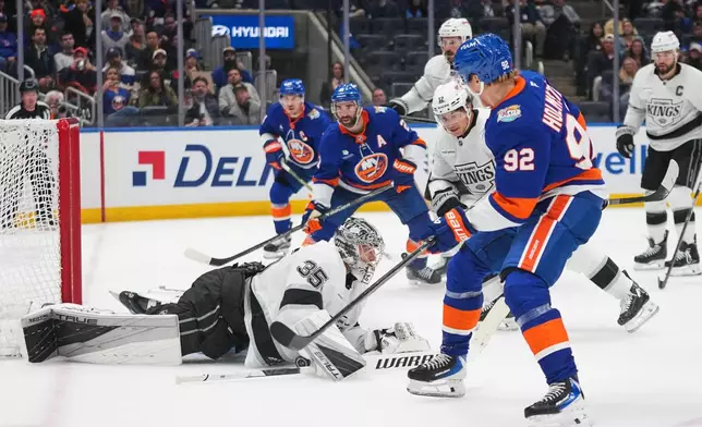 Los Angeles Kings goaltender Darcy Kuemper (35) stops a shot by New York Islanders' Simon Holmstrom (92) during the second period of an NHL hockey game Thursday, Oct. 22, 2026, in Elmont, N.Y. (AP Photo/Frank Franklin II)
