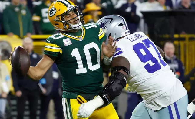 Dallas Cowboys' Kenny Clark sacks Green Bay Packers' Jordan Love during the second half of an NFL football game in Green Bay, Wis., Sunday, Oct. 18, 2026. (AP Photo/Mike Roemer)