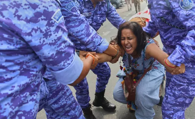 Police detain a protester during a demosntrationt demanding the resignation of Chief Election Commissioner Gyanesh Kumar during a protest in New Delhi, India, Sunday, Oct. 11, 2026. (AP Photo/Prabhat Mehrota)