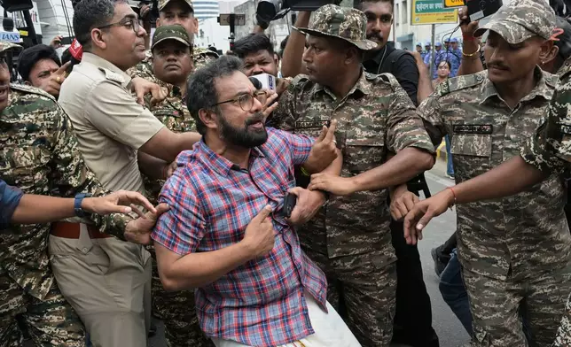 Police detain Communist Party of India (Marxist) lawmaker John Brittas during a demonstration demanding the resignation of Chief Election Commissioner Gyanesh Kumar during a protest in New Delhi, India, Sunday, Oct. 11, 2026. (AP Photo/Sanjeev Rastogi)
