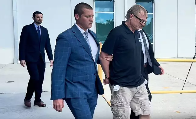 In this image taken from video released by the Orlando Police Department, Dale Smith Jr. is taken into custody in Orlando, Fla., on Wednesday, Oct. 14, 2026. (Orlando Police Department via AP)