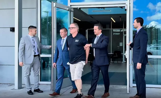 In this image taken from video released by the Orlando Police Department, Dale Smith Jr. is taken into custody in Orlando, Fla., on Wednesday, Oct. 14, 2026. (Orlando Police Department via AP)