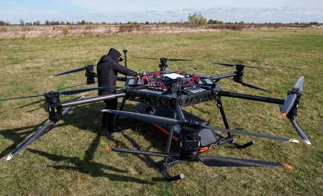 A representative of the SkyFall drone company checks the SkyGate drone before a demonstration flight at an undisclosed location in Ukraine, Wednesday, Oct. 14, 2026. (AP Photo/Evgeniy Maloletka)