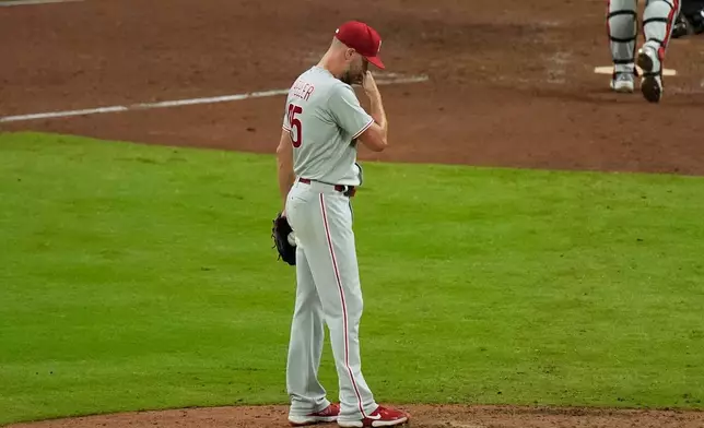 Philadelphia Phillies pitcher Zack Wheeler stands on the mound between batters against the Atlanta Braves in the sixth inning during Game 3 of baseball's NL Wild Card Series, Thursday, Oct. 1, 2026, in Atlanta. (AP Photo/Mike Stewart)
