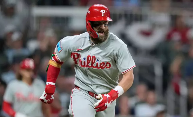 Philadelphia Phillies' Bryce Harper hits a double against the Atlanta Braves in the sixth inning during Game 3 of baseball's NL Wild Card Series, Thursday, Oct. 1, 2026, in Atlanta. (AP Photo/Brynn Anderson)