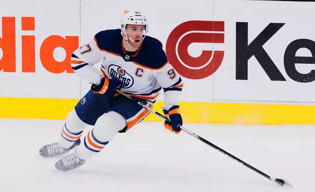 Edmonton Oilers center Connor McDavid (97) skates with the puck during the first period of an NHL hockey game against the Utah Mammoth Saturday, Oct. 17, 2026, in Salt Lake City. (AP Photo/Melissa Majchrzak)