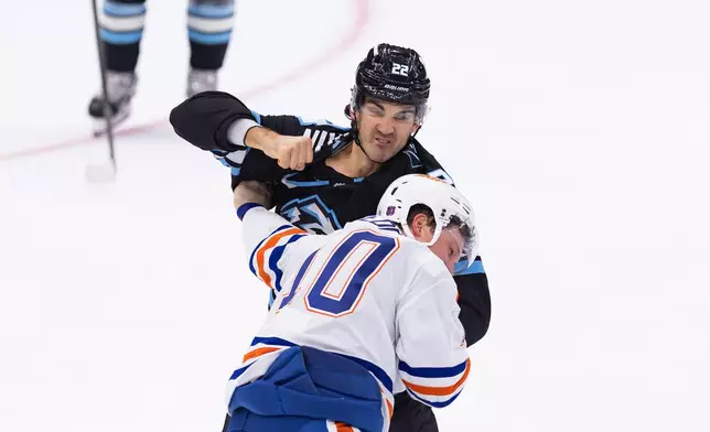 Utah Mammoth center Jack McBain (22) fights with Edmonton Oilers center Trent Frederic (10) during the first period of an NHL hockey game Saturday, Oct. 17, 2026, in Salt Lake City. (AP Photo/Melissa Majchrzak)