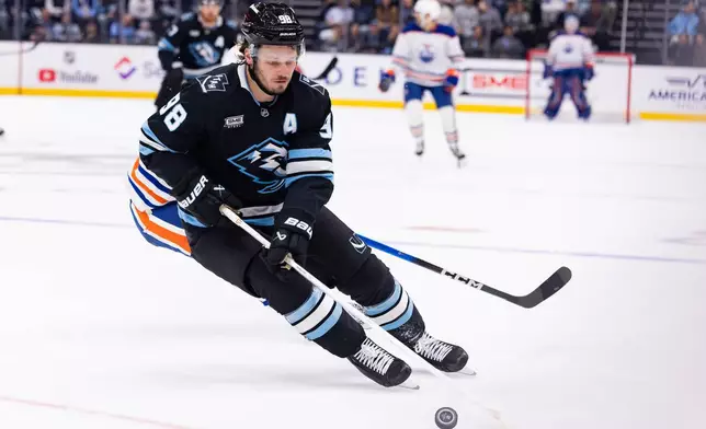 Utah Mammoth defenseman Mikhail Sergachev (98) skates with the puck during the second period of an NHL hockey game against the Edmonton Oilers Saturday, Oct. 17, 2026, in Salt Lake City. (AP Photo/Melissa Majchrzak)