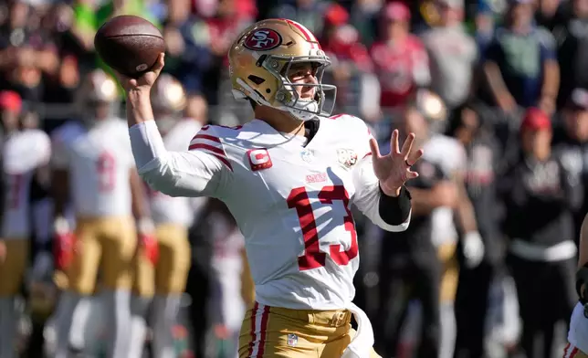 San Francisco 49ers quarterback Brock Purdy throws a pass against the Seattle Seahawks during the first half of an NFL football game Sunday, Oct. 11, 2026, in Seattle. (AP Photo/Stephen Brashear)