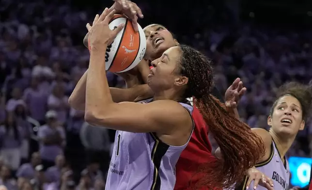 Golden State Valkyries center Kiah Stokes, bottom, is fouled by Atlanta Dream forward Angel Reese, top, during the second half of Game 1 of the WNBA basketball finals, Saturday, Oct. 17, 2026, in San Francisco. (AP Photo/Jeff Chiu)