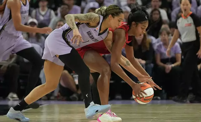 Golden State Valkyries forward Gabby Williams, left, reaches for the ball against Atlanta Dream forward Angel Reese during the first half of Game 1 of the WNBA basketball finals, Saturday, Oct. 17, 2026, in San Francisco. (AP Photo/Jeff Chiu)