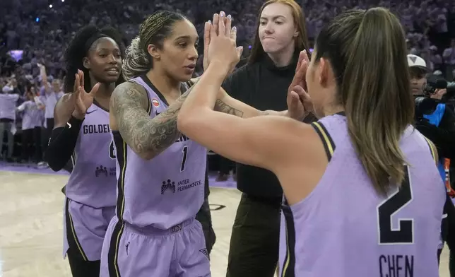 Golden State Valkyries guard-forward Kaila Charles, left, celebrates with forward Gabby Williams (1) and guard Kaitlyn Chen (2) after Game 1 of the WNBA basketball finals against the Atlanta Dream, Saturday, Oct. 17, 2026, in San Francisco. (AP Photo/Jeff Chiu)