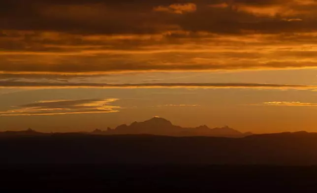 The Mont Blanc is pictured in the early morning from Poleymieux-au-Mont-d'Or, France, Tuesday, Oct. 13, 2026. (AP Photo/Laurent Cipriani)