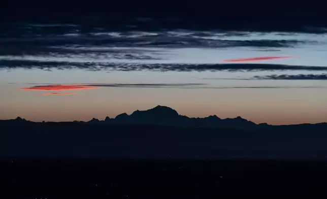 The Mont Blanc is pictured in the early morning from Poleymieux-au-Mont-d'Or, France, Tuesday, Oct. 13, 2026. (AP Photo/Laurent Cipriani)