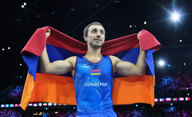 Artur Davtyan, of Armenia, celebrates after winning the gold medal in the vault during the apparatus finals at the Artistic Gymnastics World Championships in Rotterdam, the Netherlands, Sunday, Oct. 25, 2026. (AP Photo/Patrick Post)