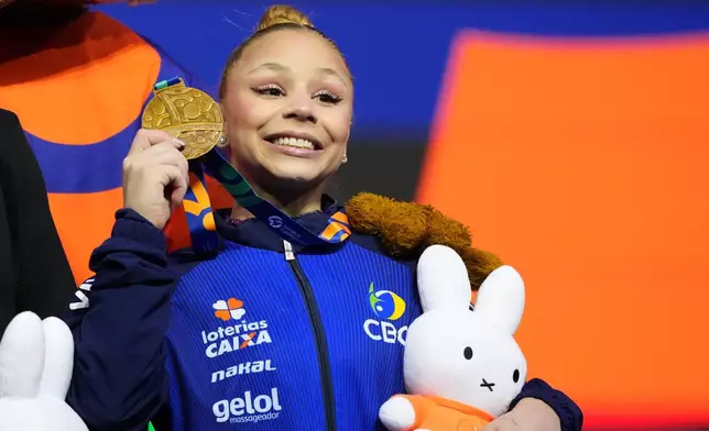 Flavia Saraiva, of Brazil, poses on the podium after winning the bronze medal in the beam during the apparatus finals at the Artistic Gymnastics World Championships in Rotterdam, the Netherlands, Sunday, Oct. 25, 2026. (AP Photo/Patrick Post)