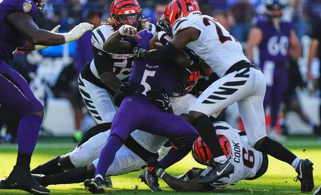 Cincinnati Bengals players sack Baltimore Ravens quarterback Tyler Huntley (5) during the second half of an NFL football game in Baltimore, Sunday, Oct. 25, 2026. (AP Photo/Stephanie Scarbrough)