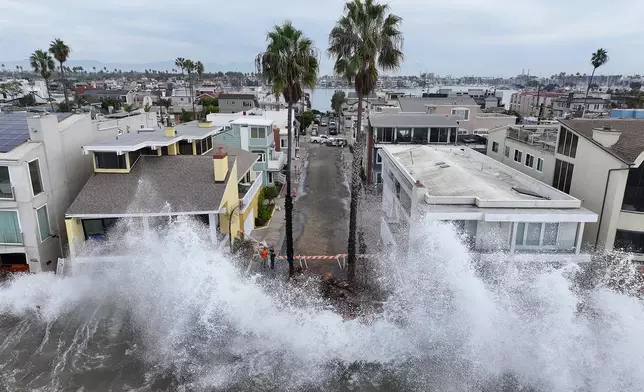 Waves hit a walkway in front of homes in Long Beach, Calif., Saturday, Oct. 10, 2026, as Tropical Storm Rachel approaches. (AP Photo/William Liang)