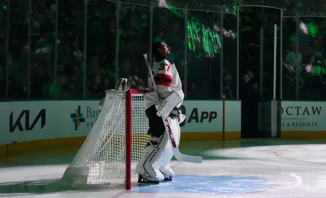 New Jersey Devils goaltender Connor Hellebuyck takes the ice prior to an NHL hockey game against the New Jersey Devils, Tuesday, Oct. 27, 2026, in Dallas. (AP Photo/Julio Cortez)