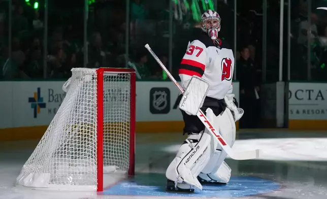New Jersey Devils goaltender Connor Hellebuyck takes the ice prior to an NHL hockey game against the New Jersey Devils, Tuesday, Oct. 27, 2026, in Dallas. (AP Photo/Julio Cortez)