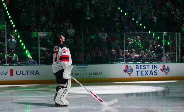 New Jersey Devils goaltender Connor Hellebuyck takes the ice prior to an NHL hockey game against the New Jersey Devils, Tuesday, Oct. 27, 2026, in Dallas. (AP Photo/Julio Cortez)