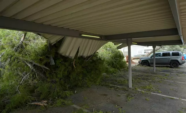 Part of a covered parking area was damaged after storms hit a local apartment complex, Wednesday, Oct. 21, 2026, in Mesa, Ariz. (AP Photo/Ross D. Franklin)