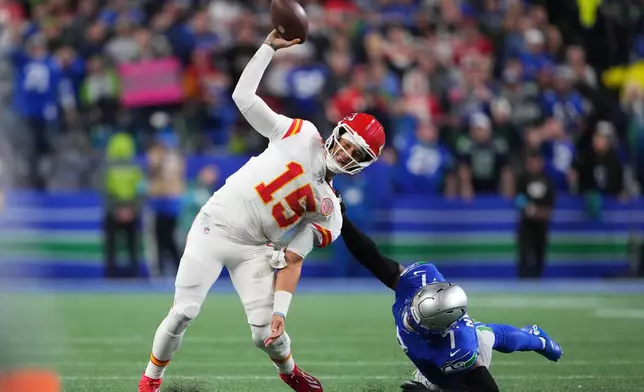 Kansas City Chiefs quarterback Patrick Mahomes tries to pass under pressure from Seattle Seahawks linebacker Uchenna Nwosu (7) during the second half of an NFL football game in Seattle, Sunday, Oct. 25, 2026. (AP Photo/Lindsey Wasson)