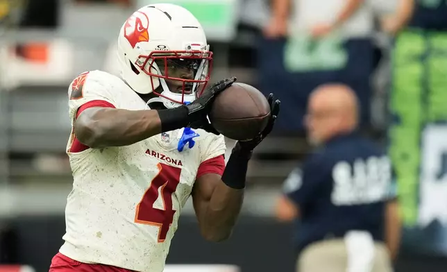 Arizona Cardinals running back Jeremiyah Love makes a catch while warming up before an NFL football game against the Seattle Seahawks in Glendale, Ariz., Sunday, Sept. 20, 2026. (AP Photo/Ross D. Franklin)