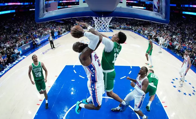 Philadelphia 76ers' LeBron James, left, goes up for a shot against Boston Celtics' Chris Cenac Jr. during the first half of a preseason NBA basketball game Friday, Oct. 16, 2026, in Philadelphia. (AP Photo/Matt Slocum)