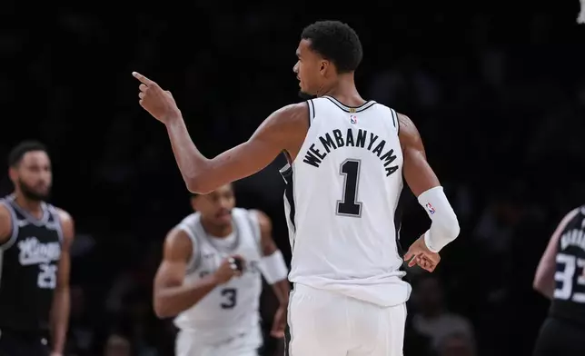 San Antonio Spurs forward Victor Wembanyama (1) reacts to a play during the first half of a preseason NBA basketball game against the Sacramento Kings in San Antonio, Friday, Oct. 16, 2026. (AP Photo/Eric Gay)